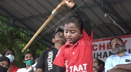 Indian child archer shoots 75 arrows at moving target above her head while standing on nails