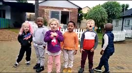 Pre-school kids singing in the morning before class starts with teachers.
