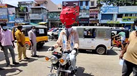 Man disguised like corona spread awareness in public places in South India