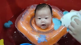 Adorable 02-month-old baby enjoys her homemade baby spa by her parents