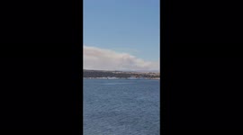 Locals applaud as firefighters fill up aircraft with water to combat ongoing blazes in Spain