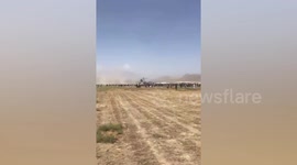 Apache helicopter clears people from runway so C-17 can take-off in Afghanistan