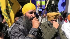 Protesters outside the High Commission of India, London, threaten to drag Prime Minister Narendra Modi with a rope from the back of a tractor.