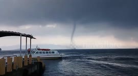 Waterspout forms near pier where yacht docks in the Philippines