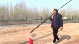 Chinese man demonstrates incredible skill as he picks up ball with 4.6-metre-long chopsticks