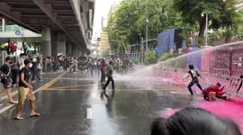 Thai agitators vandalise police HQ with pink paint during clashes in Bangkok