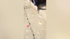 Afghan locals gather near Kabul airport as Taliban guards roam