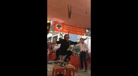 Terrifying street-circus stunt sees man balance knife-laden pole in mouth while wobbling on board