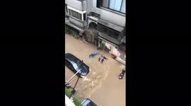 Road rivals: Car knocks mopeds over like dominos, others soak riders with puddles