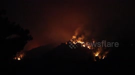 Wildfires burning the forest during the night on Evia Island in Greece