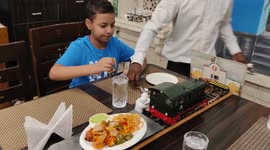 Chew chew! Indian restaurant uses model train set to deliver food to diners