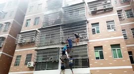 Chinese residents form human ladder to rescue two girls trapped in burning flat