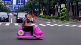 Police officers stop elderly Chinese woman driving toy car on busy road