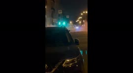 Crazy St Petersburg nights: Man with a fire extinguisher rides a refuse bin