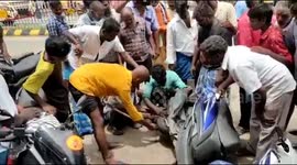 Daring man pulls large snake from out of local's motorcycle in southern Inida