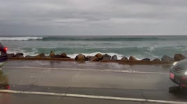 Car Wash - Watch as huge waves crash over cars on California beach road