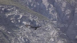Stunning footage show two majestic vultures fighting above Swiss Alps