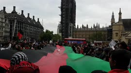 Afghan flag carried by protesters makes its way along Whitehall and Parliament Square