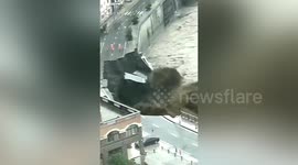 Large section of road collapses into swelling river in nothern China