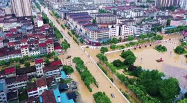 Firefighters rescue residents trapped in deep floodwater after heavy rainstorm in China