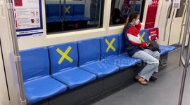 Passengers follow Covid-19 social distancing rules on subway train in Bangkok