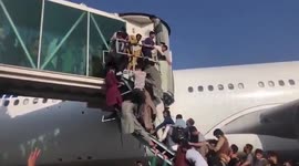 Afghans clamber onto plane to flee the country after Taliban victory