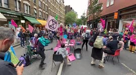 Extinction Rebellion protesters play musical chairs in Charing Cross Road during the Impossible Rebellion protest, London, UK 23/08/2021