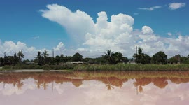 Mirror-like reflection of clouds and blue sky in a saltwater pond from seawater being desalinated for salt extraction in the community of Yavaros, municipality of Huatabampo, Sonora, Mexico. hydraulic or salt solution extraction, water below the surface o