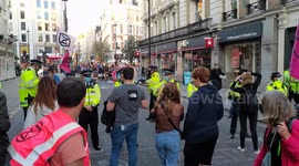 Police seal of the road of the Exctinction Rebellion activists sitin protest against Climate change in Leicester Square, London, UK