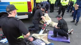 Specialist police teams arrest two climate change activists from a concrete 'lock-on' tube at Extinction Rebellion protest