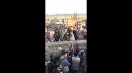 (Drenched in feces/urine) Afghans at Hamid Karzai International Airport (HKIA) in a large trench filled with sewer water full of feces and urine (only way to get to airport gates)