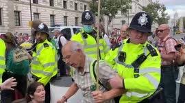Police attempt to remove Extinction Rebellion protesters blocking road near Downing Street