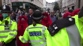 Excitation Rebellion the red lady  stares in to police women's eyes  after denied enter to main part of the protest
