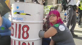 Extinction Rebellion (XR) activists lock themselves to barrels as they block Whitehall in London