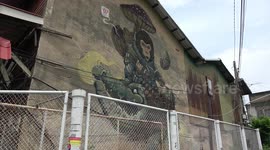 Thai village decorated with dozens of crocodile street art murals