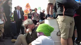 Extinction Rebellion XR Cymru Action protesters block the road in Whitehall, London on day 2 of The Impossible Rebellion