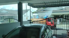 Volunteers use small lorry to disinfect Malaysian housing area