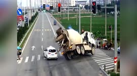 Concrete mixer truck flips over after collision, injuring 3 in China