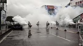 Chinese workers blow clouds of disinfectant onto streets after COVID-19 lockdown lifted