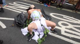 Injured bride played by Extinction Rebellion protestor against genocide in Brazil at Brazilian Embassy in London