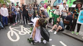 Screaming and strangled bride played by Extinction Rebellion protestor outside Brazilian Embassy in London