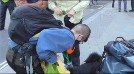 Extinction rebellion 5  protesters and a dog chained to a concrete glob young boy relative collects the dog from protester