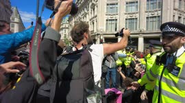 Scuffles ensue as Police try to contain the situation as Extinction Rebellion Impossible Rebellion protesters take over Oxford Circus by blocking the road