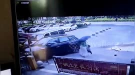 Chinese woman moves boy from out of harm's way as vehicle recklessly skids through car park