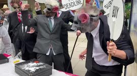 Extinction Rebellion protesters with rat masks pretend to snort sherbert during a demonstration in London, UK, 26/08/2021