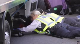 Extinction Rebellion protesters chained to underneath of lorry in London