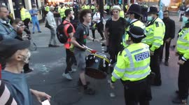drummer ordered to leave the area police carry many protesters out after being arrested