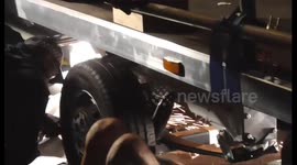 sparks fly  as Extinction rebellion protesters chained under a lorry are arrested