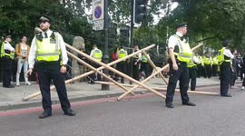 Climate change protesters stage demonstrate against fossil fuel sponsorship by blocking road in Kensington