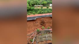 Two pedestrians narrowly escape as hillside road collapses underneath them in central China